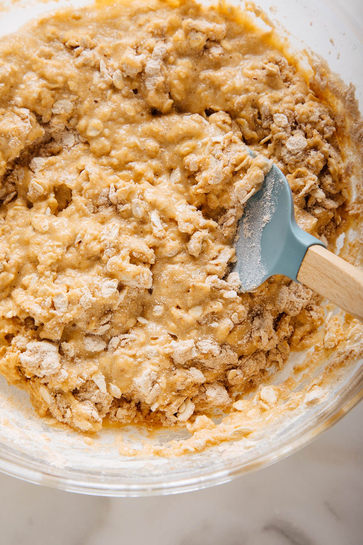 stirring apple oatmeal muffin batter