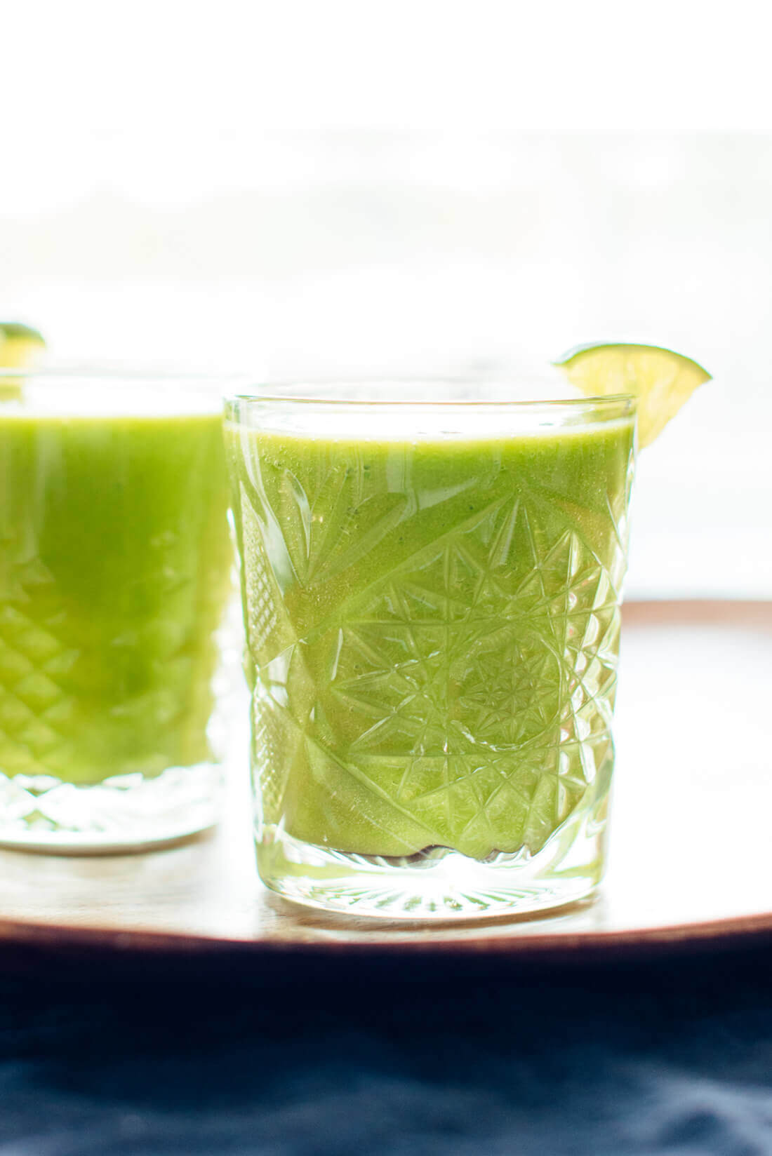 This "mango-rita" green smoothie recipe is made with frozen mango and pineapple, fresh orange, spinach and lime! cookieandkate.com