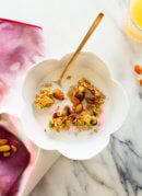 Orange almond granola in cereal bowl with milk