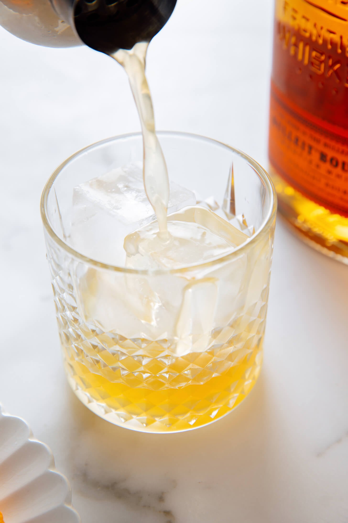 pouring whiskey sour